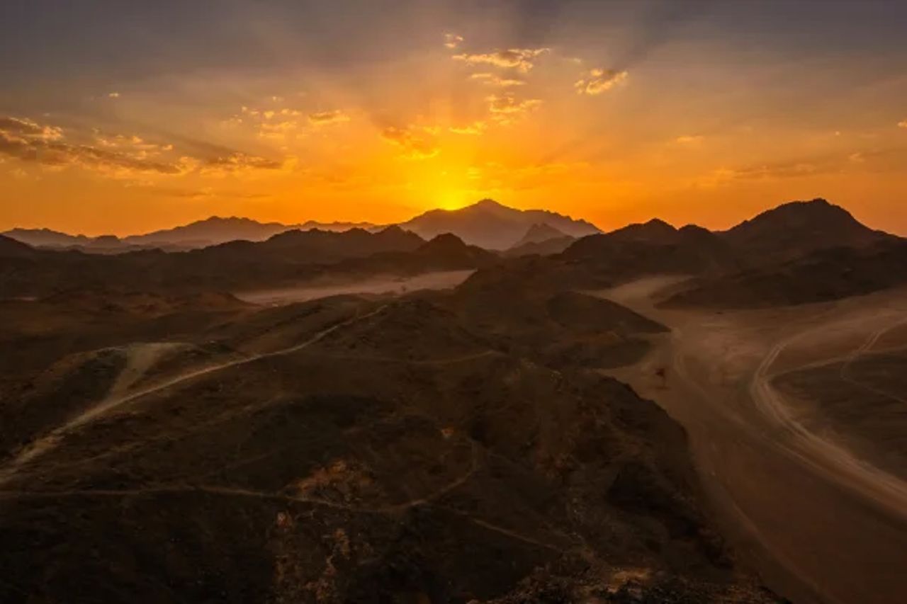 Egyptian desert landscape with sand dunes at sunset