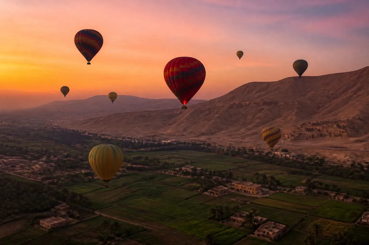 Hot air balloons over the Luxor west bank at sunrise