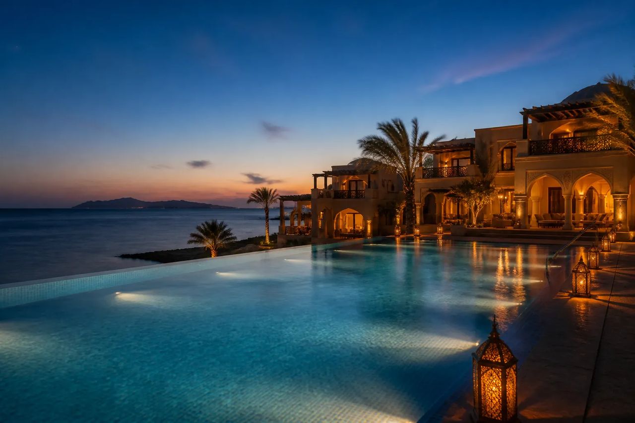 Red Sea luxury resort infinity pool at dusk overlooking the sea