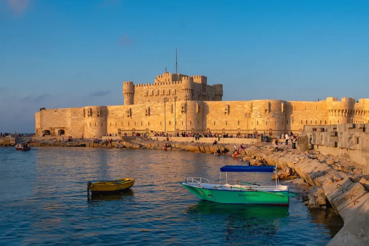 Qaitbay Citadel on the Mediterranean waterfront with small boats in front