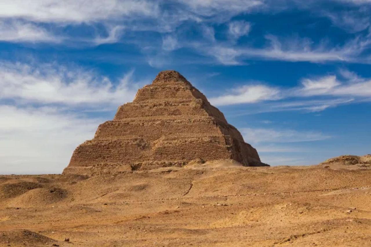 Step Pyramid of Djoser rising from the desert under a blue sky