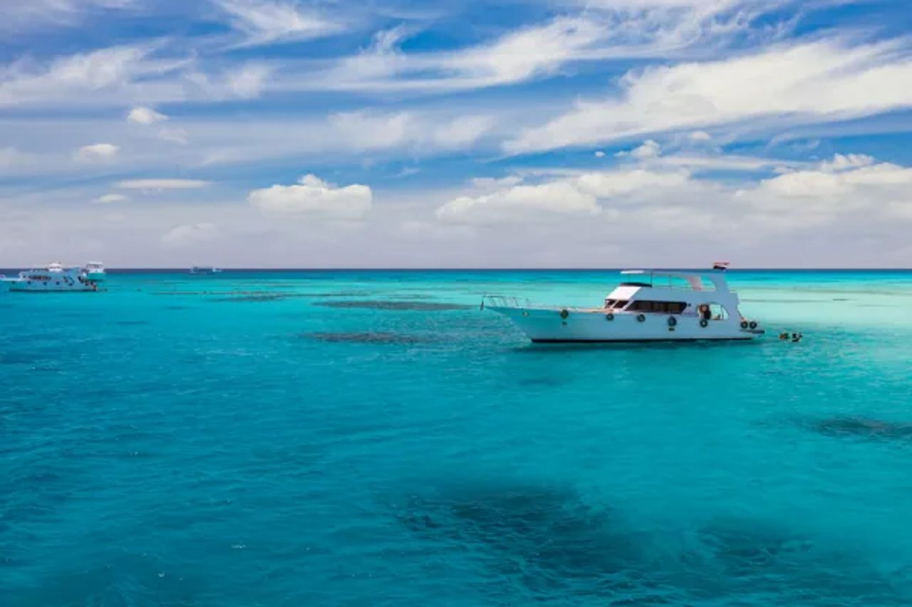 Small white boat on turquoise water off Hurghada