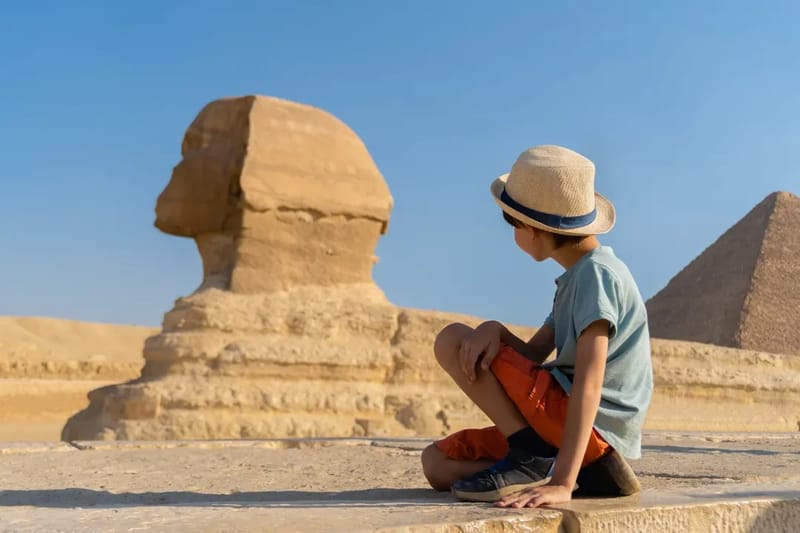 Young traveller sitting beside the Great Sphinx at Giza