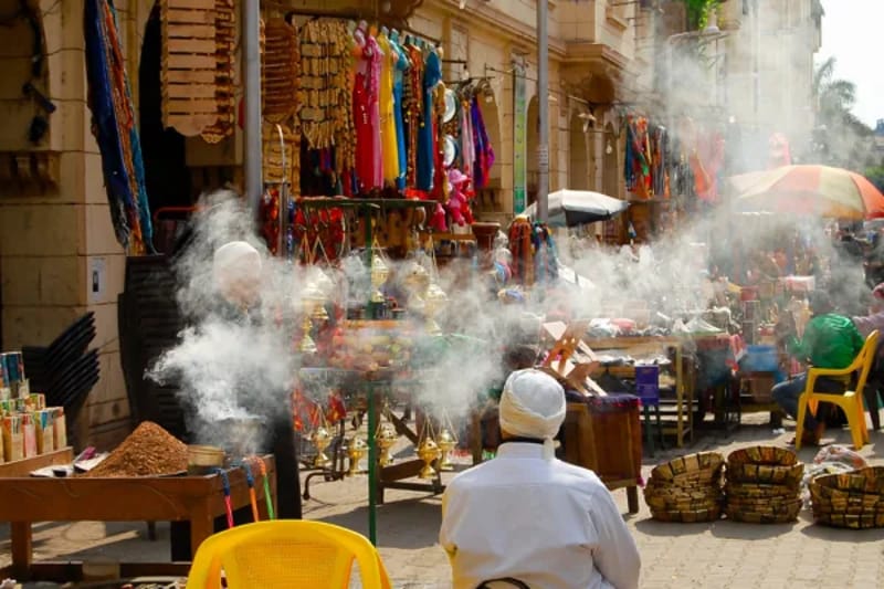 Incense smoke and hanging textiles at a bazaar stall in Khan el-Khalili, Cairo