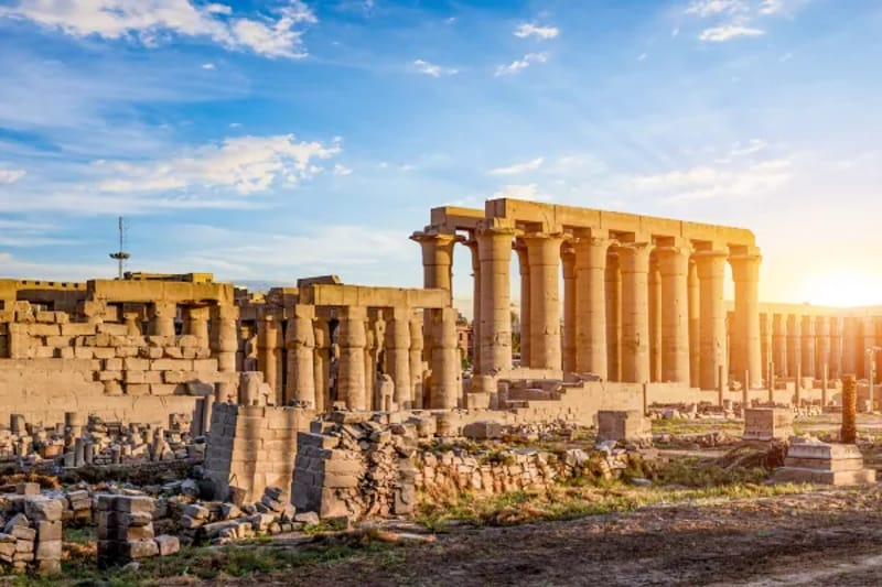 Ruined colonnade of Luxor temple in low sun