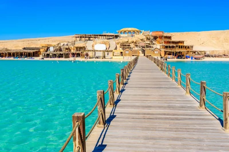 Wooden jetty leading to beach buildings at Orange Bay